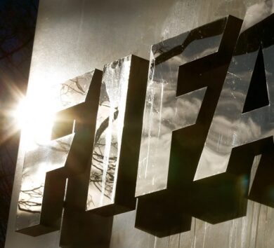 FILE PHOTO: The sun is reflected in FIFA’s logo in front of FIFA’s headquarters in Zurich