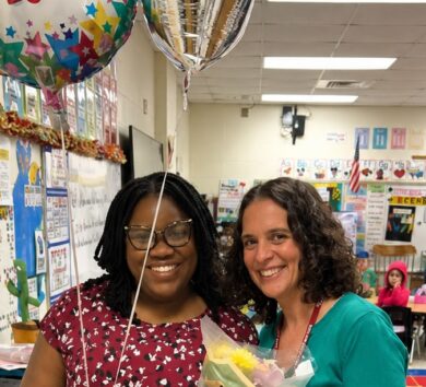 Tamar Blair Robinson is congratulated as teacher of the year by Christine Cox Instructional Coach