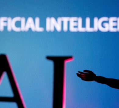 FILE PHOTO: Illustration shows AI (Artificial Intelligence) letters and robot miniature